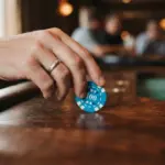 A warm, inviting close-up of a human hand gently placing a single, brightly colored casino chip onto a rich